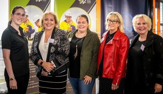 5 women of mixes ages stand side by side, smiling